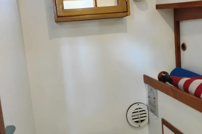 Slide: The Image of Interior of 1978 Puget 38 Europa Trawler with wooden accents and nautical decor. - 57