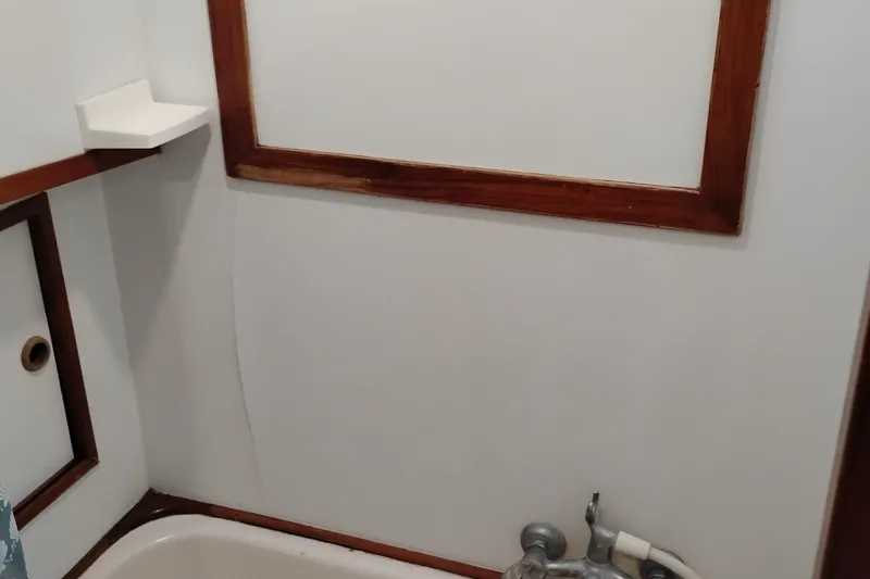 Slide: The Image of 1978 Puget 38 Europa Trawler bathroom with wood trim and bathtub. - 58