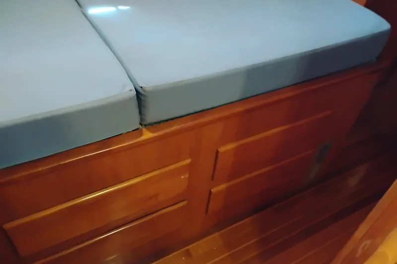 Slide: The Image of Wooden storage drawers with blue cushions on a 1978 Puget 38 Europa Trawler. - 59