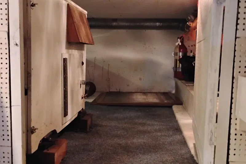 Slide: The Image of Engine room of 1978 Puget 38 Europa Trawler with equipment and fire extinguisher. - 68