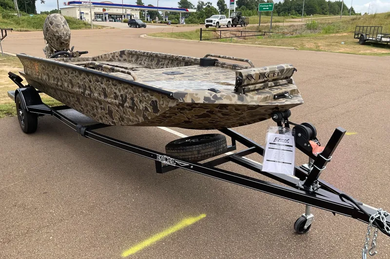 Slide: The Image of 2026 Excel 1751 Viper Duck Boat on trailer, camo design, parked outdoors. - 5