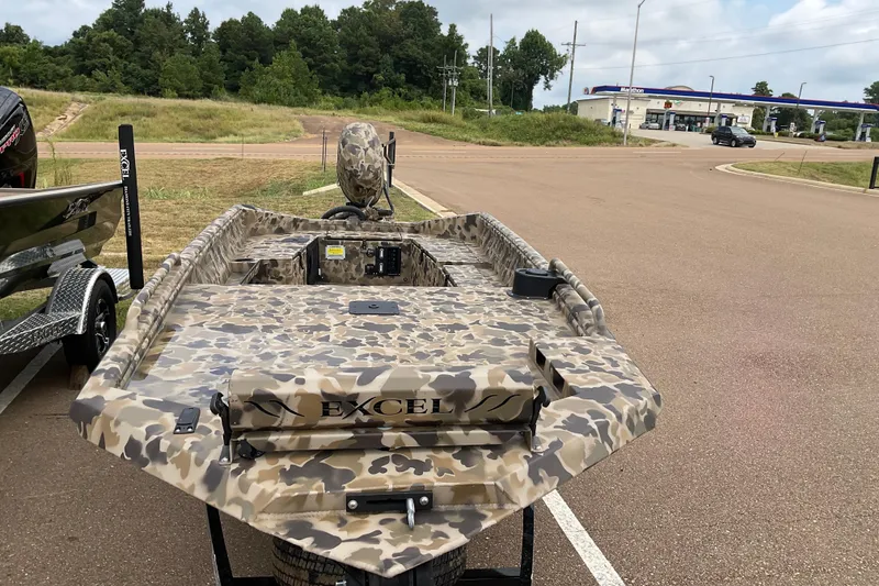 Slide: The Image of 2026 Excel 1751 Viper Duck Boat with camouflage design parked outdoors. - 6
