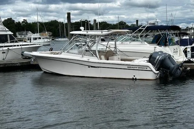 The Image of 2013 Grady-White Freedom 285 boat docked in a marina, overcast sky. - 1