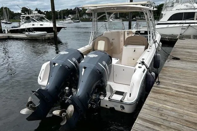 Slide: The Image of 2013 Grady-White Freedom 285 boat docked with twin outboard engines. - 11