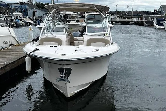 Slide: The Image of 2013 Grady-White Freedom 285 boat docked in a marina, front view. - 12