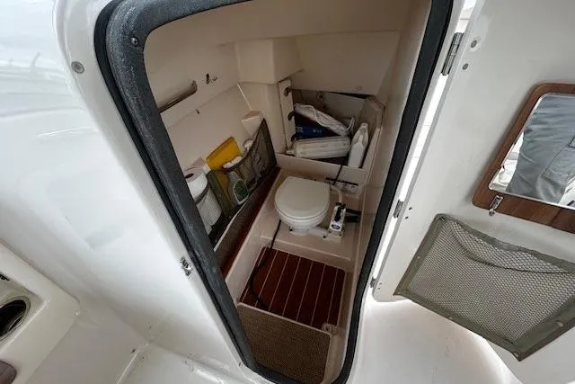 Slide: The Image of 2013 Grady-White Freedom 285 boat interior with compact bathroom amenities. - 4