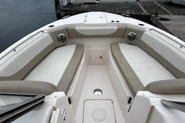 Slide: The Image of 2013 Grady-White Freedom 285 boat interior with cushioned seating and speakers. - 7