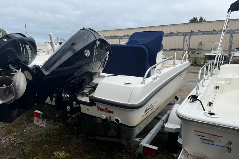 Slide: The Image of 2017 Boston Whaler 170 Dauntless boat with Mercury engine, parked on a trailer. - 1