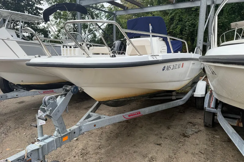 Slide: The Image of 2017 Boston Whaler 170 Dauntless boat on trailer, parked outdoors. - 3