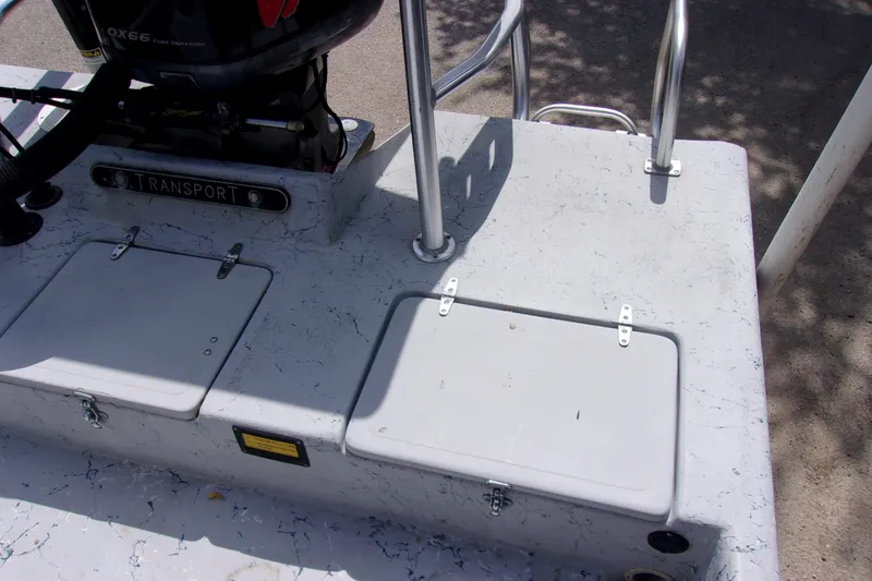 Slide: The Image of Rear deck of a 2004 Tran Cat 21 boat with storage compartments and motor. - 6