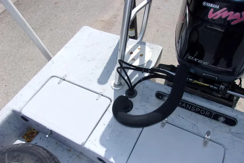 Slide: The Image of 2004 Tran Cat 21 boat deck with Yamaha OX66 engine, featuring storage compartments. - 7