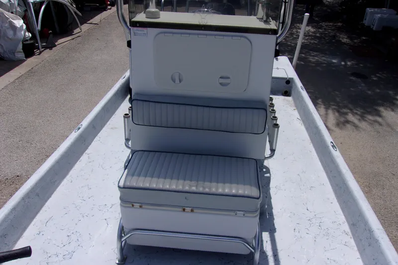 Slide: The Image of 2004 Tran Cat 21 boat interior with cushioned seating and storage compartments. - 8