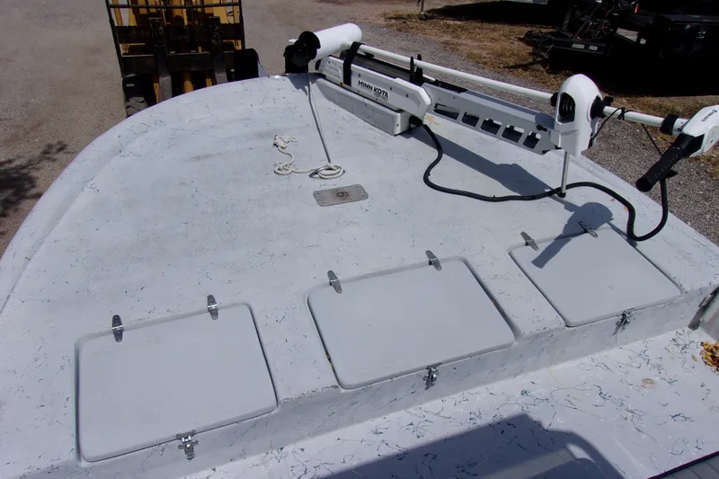 Slide: The Image of 2004 Tran Cat 21 boat deck with Minn Kota trolling motor and storage hatches. - 9