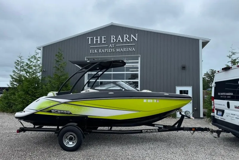 Slide: The Image of 2015 Scarab 195 boat on trailer at Elk Rapids Marina, in front of The Barn. - 1