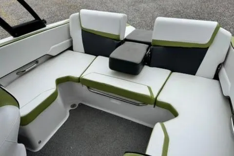 Slide: The Image of Interior seating of a 2015 Scarab 195 boat with green and white upholstery. - 13