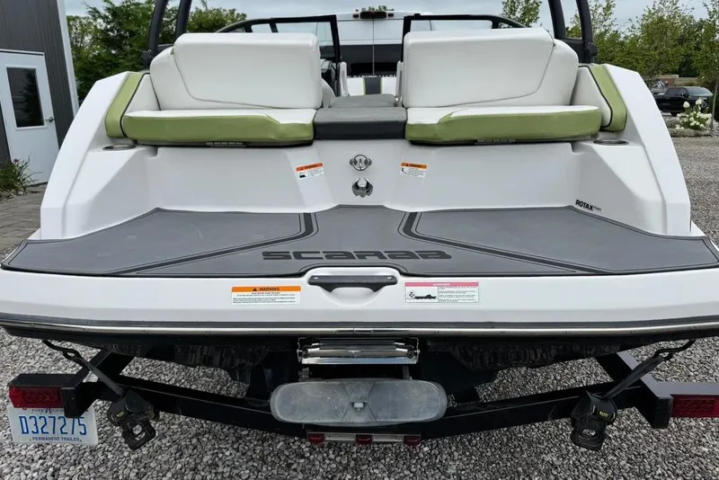 Slide: The Image of Rear view of a 2015 Scarab 195 boat with green and white seating. - 4