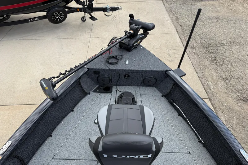 Slide: The Image of 2026 Lund 1775 Impact XS Sport boat interior with trolling motor and seating. - 11