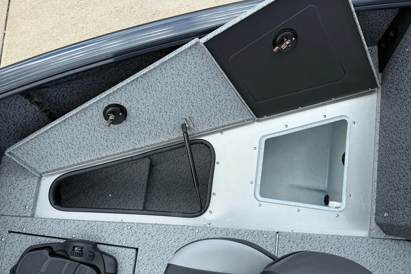 Slide: The Image of 2026 Lund 1775 Impact XS Sport boat interior storage compartments and seating area. - 14