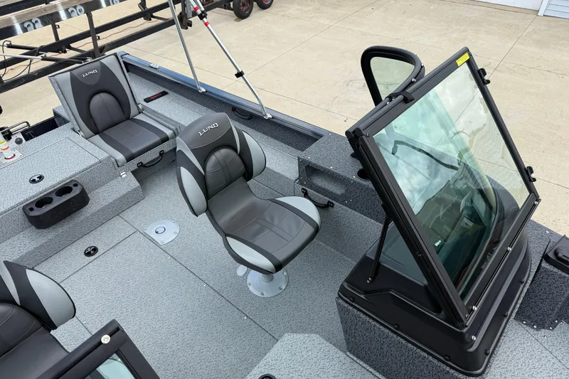 Slide: The Image of 2026 Lund 1775 Impact XS Sport boat interior with seating and windshield. - 16