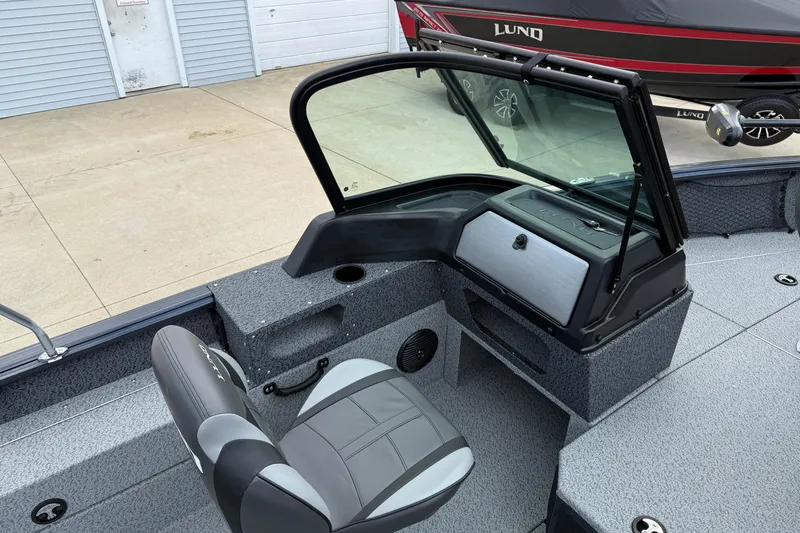 Slide: The Image of 2026 Lund 1775 Impact XS Sport boat interior with seating and console. - 19