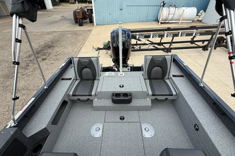 Slide: The Image of 2026 Lund 1775 Impact XS Sport boat interior with seating and motor view. - 24