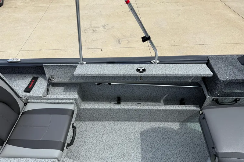 Slide: The Image of 2026 Lund 1775 Impact XS Sport boat interior with gray seating and storage compartments. - 26