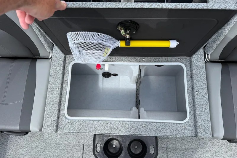 Slide: The Image of 2026 Lund 1775 Impact XS Sport boat storage compartment with net and yellow handle. - 28