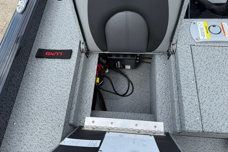 Slide: The Image of 2026 Lund 1775 Impact XS Sport boat interior with storage compartment and seat. - 30