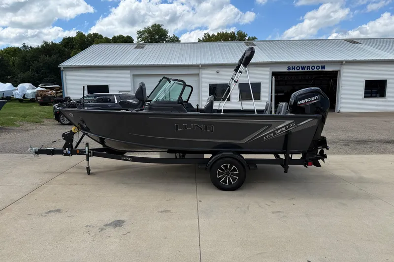 Slide: The Image of 2026 Lund 1775 Impact XS Sport boat on trailer outside showroom. - 4