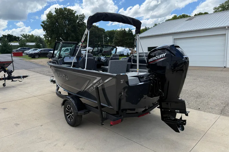 Slide: The Image of 2026 Lund 1775 Impact XS Sport boat with Mercury engine, parked outdoors. - 5