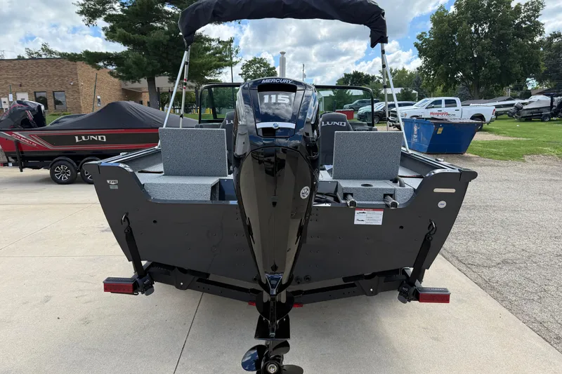 Slide: The Image of 2026 Lund 1775 Impact XS Sport boat with Mercury 115 engine, parked outdoors. - 6
