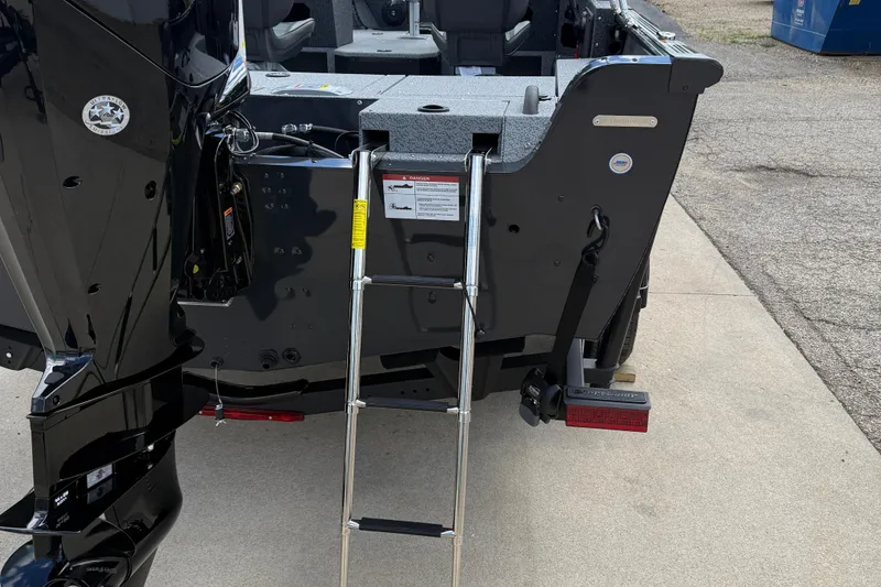 Slide: The Image of 2026 Lund 1775 Impact XS Sport boat with ladder and motor, rear view. - 7