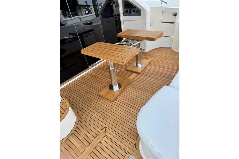 Slide: The Image of Teak deck and tables on 2008 Azimut 55 Fly yacht, showcasing luxury marine design. - 13