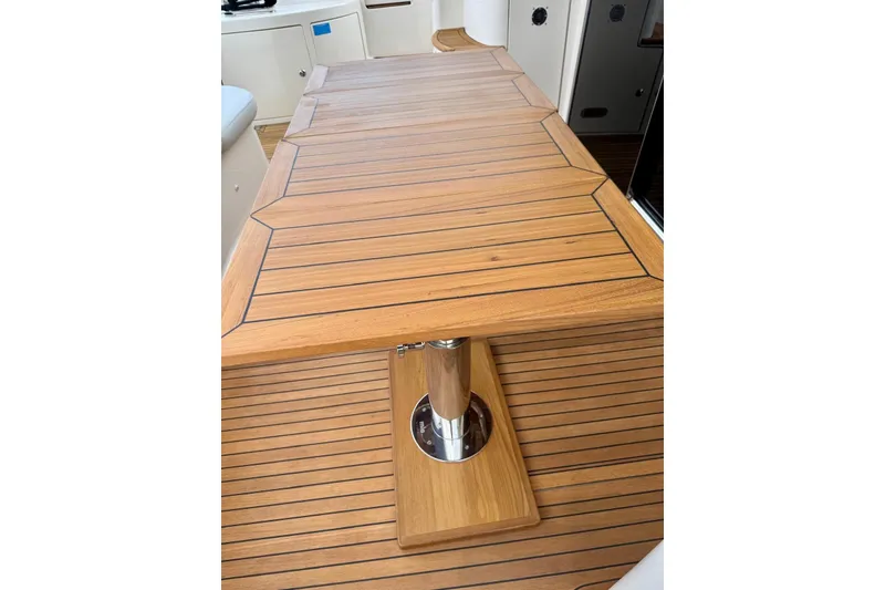 Slide: The Image of Teak table on 2008 Azimut 55 Fly yacht, showcasing elegant wood finish. - 18