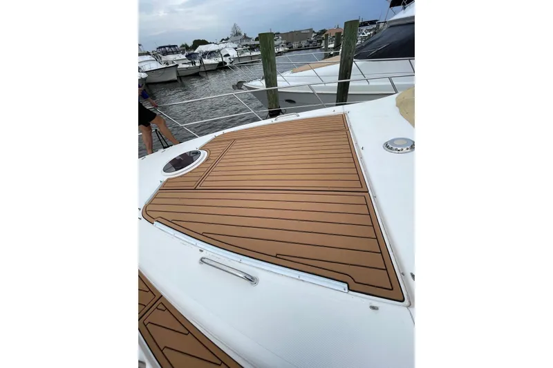 Slide: The Image of 2008 Azimut 55 Fly yacht deck with teak flooring, docked at marina. - 24