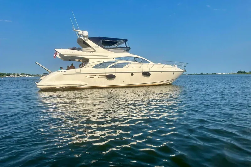 Slide: The Image of 2008 Azimut 55 Fly yacht cruising on calm blue waters under clear skies. - 3