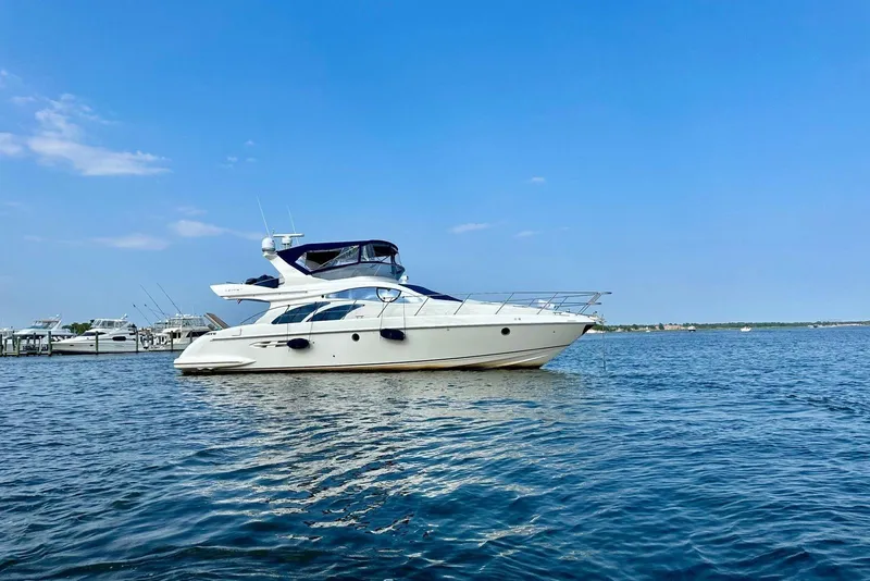 Slide: The Image of 2008 Azimut 55 Fly yacht on calm blue water under clear sky. - 4