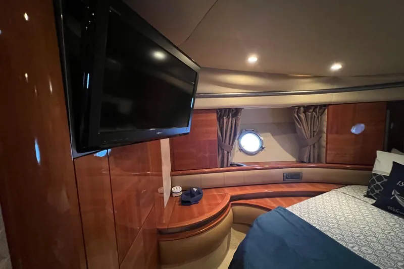 Slide: The Image of Luxurious interior of 2008 Azimut 55 Fly yacht with TV and porthole window. - 55