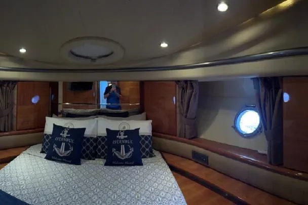 Slide: The Image of Luxurious cabin interior of 2008 Azimut 55 Fly yacht with elegant bedding and porthole. - 56