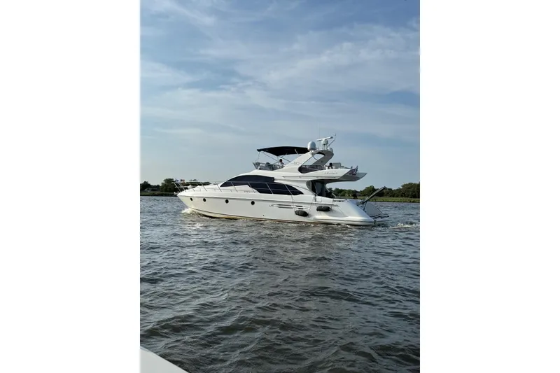 Slide: The Image of 2008 Azimut 55 Fly yacht cruising on open water under a clear sky. - 6