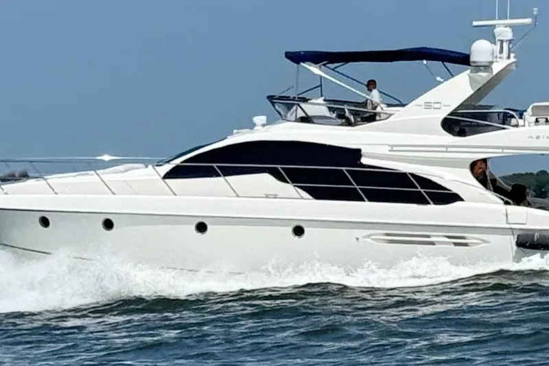Slide: The Image of 2008 Azimut 55 Fly yacht cruising on open water, side view. - 7