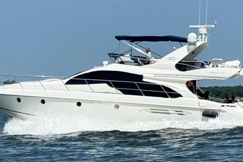 Slide: The Image of 2008 Azimut 55 Fly yacht cruising on open water, featuring sleek design and modern amenities. - 8