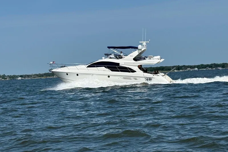 Slide: The Image of 2008 Azimut 55 Fly yacht cruising on open water under clear skies. - 9