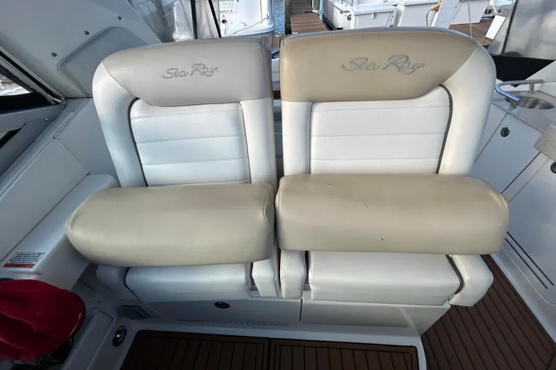 Slide: The Image of 2010 Sea Ray Sundancer 330 boat seats, beige and white leather, with logo embroidery. - 10