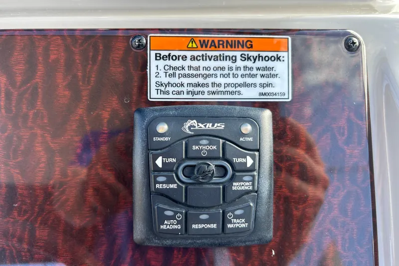 Slide: The Image of Control panel with Skyhook warning on a 2010 Sea Ray Sundancer 330 boat. - 13