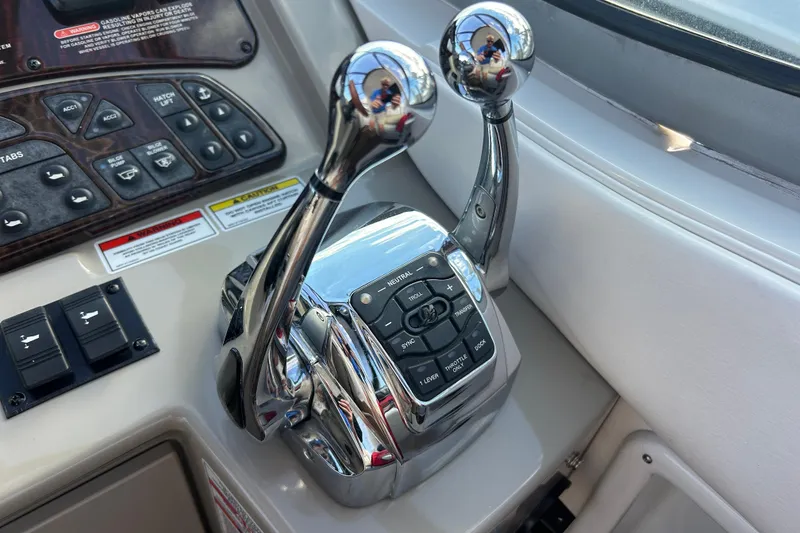 Slide: The Image of Control panel of a 2010 Sea Ray Sundancer 330 boat with dual throttle levers. - 14