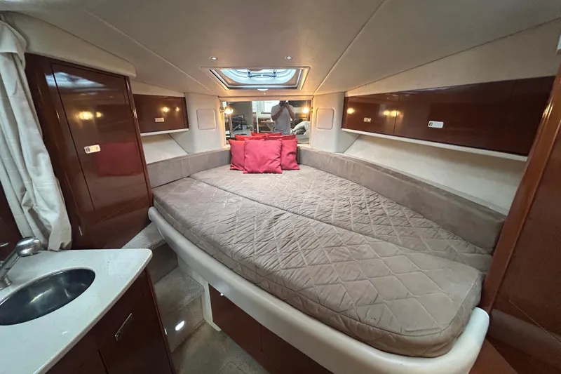 Slide: The Image of Luxurious cabin interior of 2010 Sea Ray Sundancer 330 yacht with cozy bed and elegant wood finish. - 17