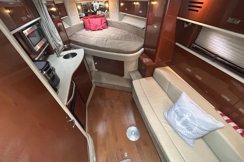 Slide: The Image of Interior of 2010 Sea Ray Sundancer 330 yacht with cozy seating and compact kitchen area. - 18