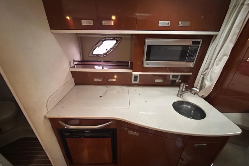 Slide: The Image of Compact kitchen area in 2010 Sea Ray Sundancer 330 yacht with sink, microwave, and storage. - 19