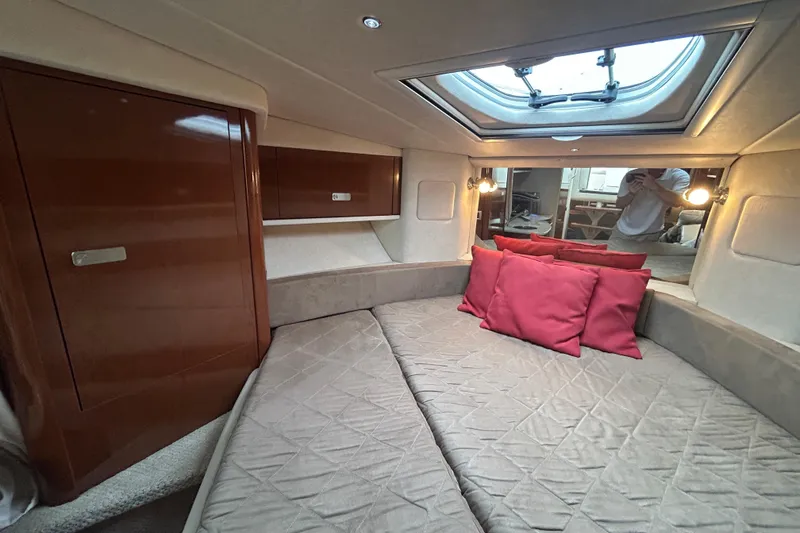 Slide: The Image of Luxurious cabin interior of 2010 Sea Ray Sundancer 330 with skylight and red cushions. - 22